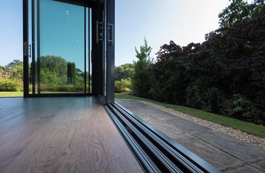 An open sliding door showing the track and panel